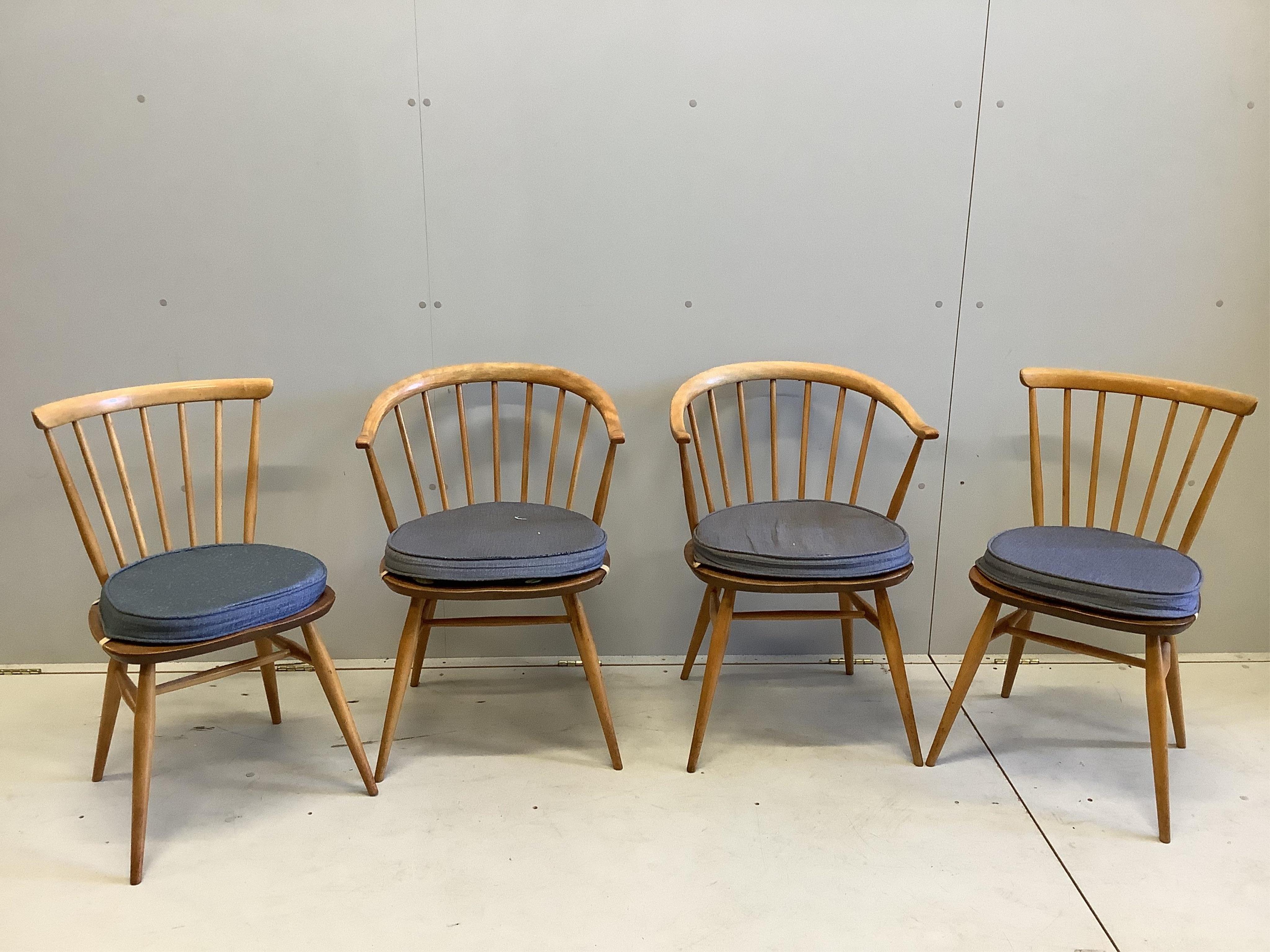 An Ercol circular elm and beech drop flap dining table, diameter 112cm, height 71cm, and four Ercol chairs. Condition - fair